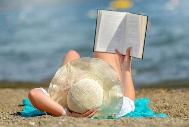 Person reading on the beach
